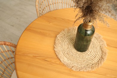 Photo of Wooden table with decor and stylish chairs in dining room, above view