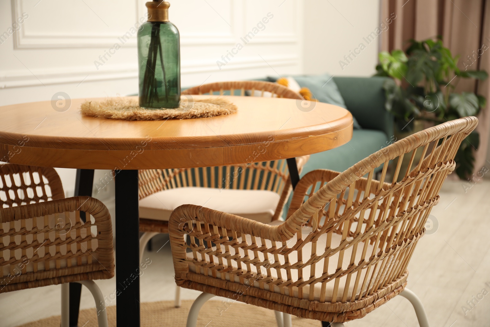 Photo of Wooden table and stylish chairs in dining room, closeup