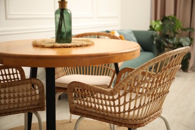 Photo of Wooden table and stylish chairs in dining room, closeup