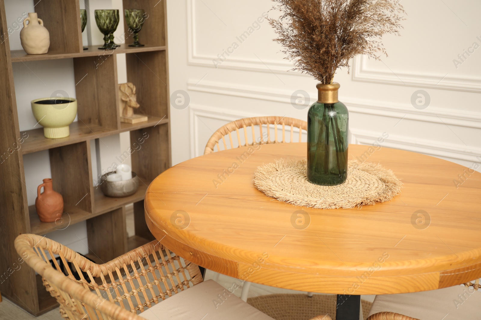 Wooden table with decor and stylish chairs in dining room, closeup Photo of Wooden table with decor and stylish chairs in dining room, closeup