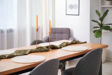 Photo of Decorated wooden table with chairs in dining room