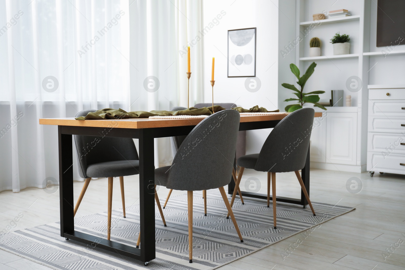 Photo of Decorated wooden table with chairs in dining room