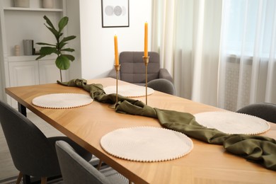Photo of Decorated wooden table with chairs in dining room