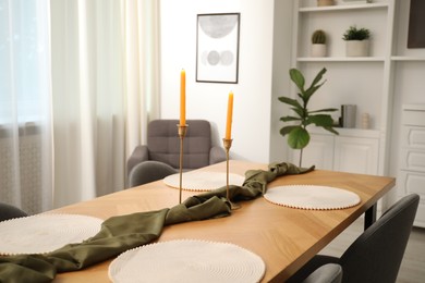 Photo of Decorated wooden table with chairs in dining room