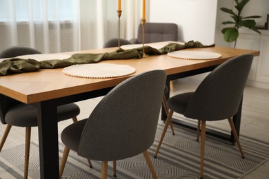 Photo of Decorated wooden table with chairs in dining room