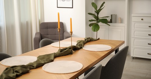 Photo of Decorated wooden table with chairs in dining room