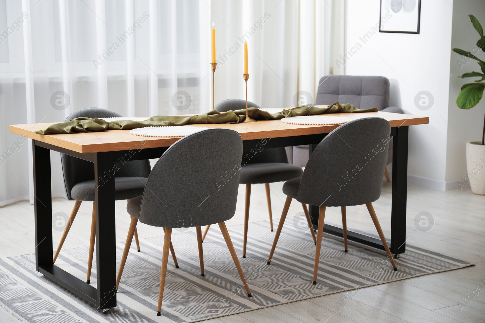 Photo of Decorated wooden table with chairs in dining room