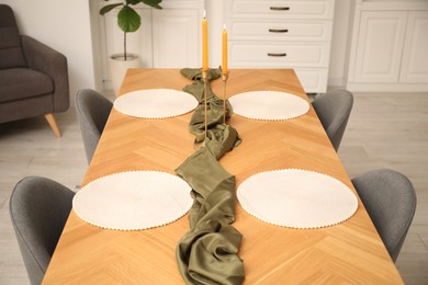 Photo of Decorated wooden table with chairs in dining room, closeup