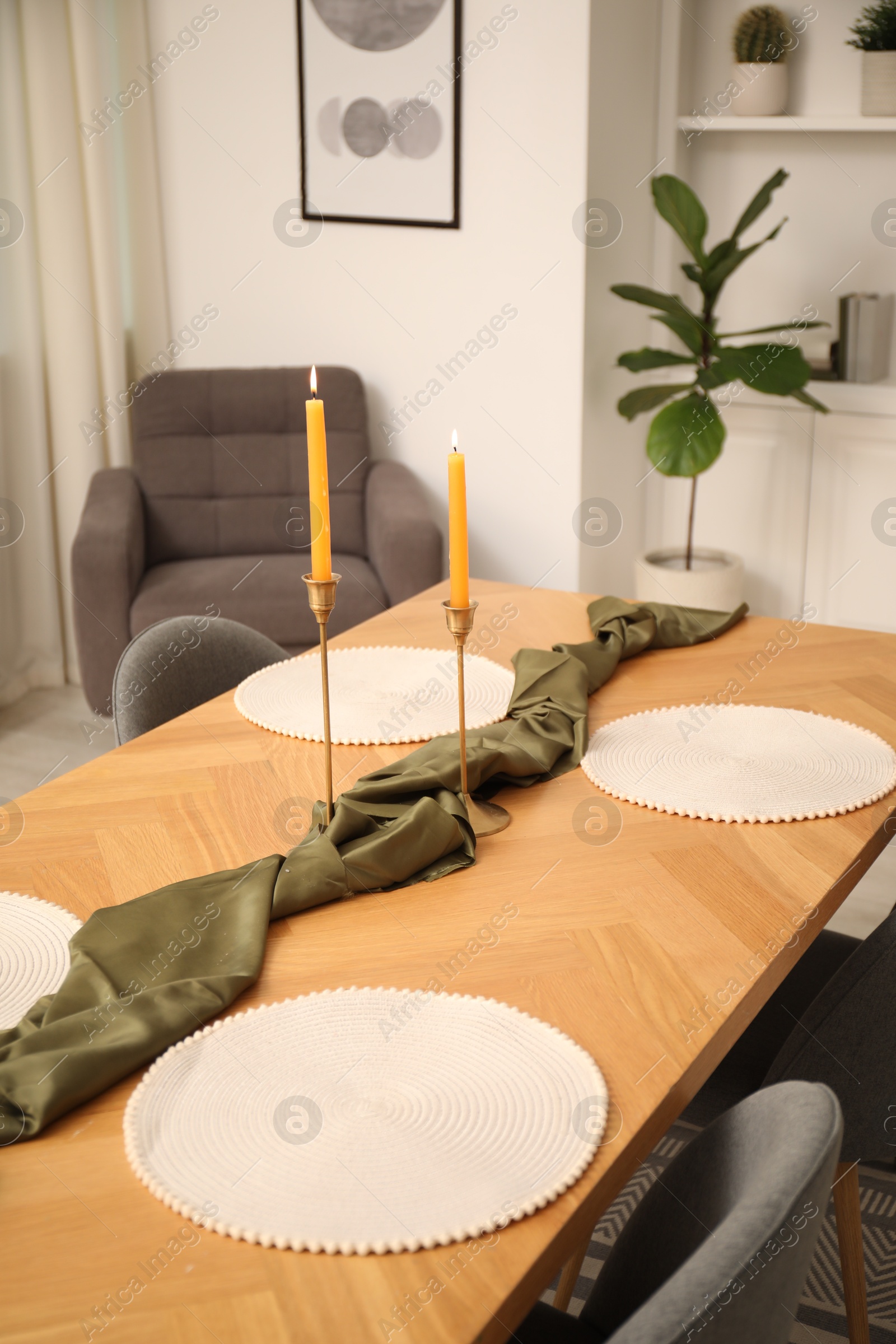 Photo of Decorated wooden table with chairs in dining room, closeup