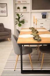 Photo of Decorated wooden table with chairs in dining room