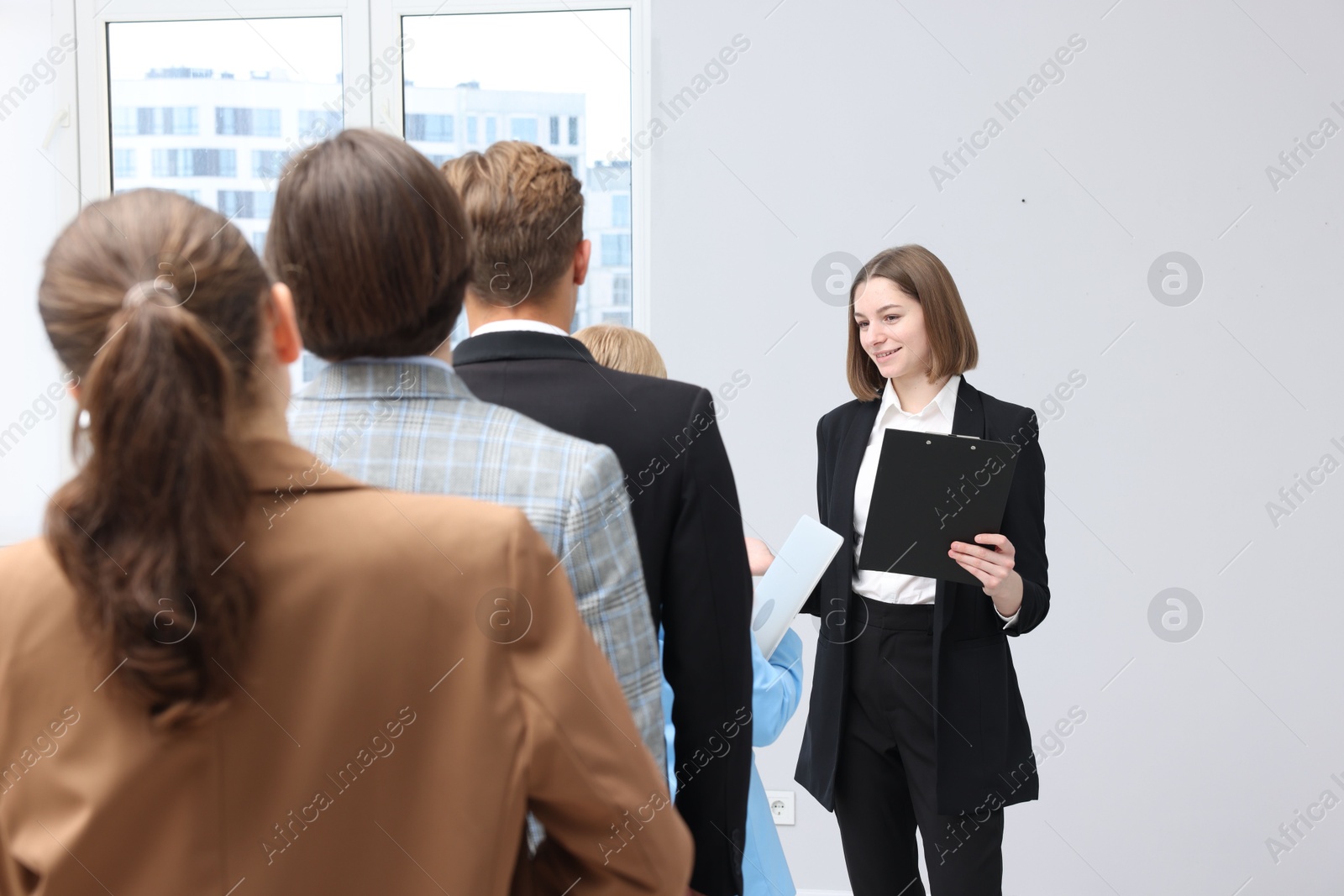 Group of people waiting in queue indoors Photo of Group of people waiting in queue indoors