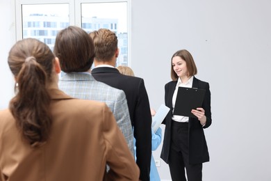 Photo of Group of people waiting in queue indoors