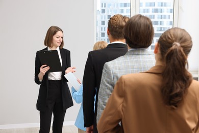Photo of Group of people waiting in queue indoors