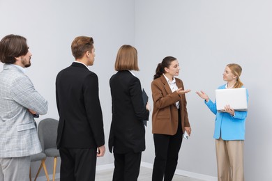 Photo of Group of people waiting in queue indoors