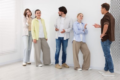 Photo of Group of people waiting in queue indoors