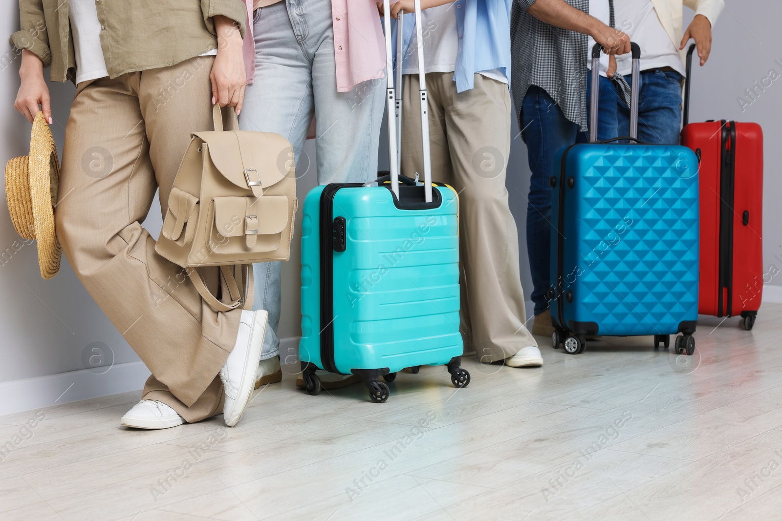 Group of people with luggages waiting in queue indoors, closeup Photo of Group of people with luggages waiting in queue indoors, closeup