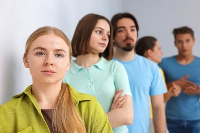 Photo of Group of people waiting in queue indoors, selective focus