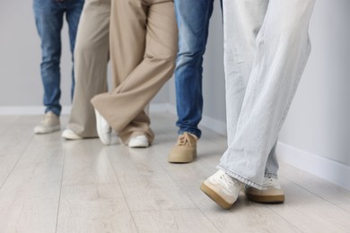 Photo of Group of people waiting in queue indoors, closeup