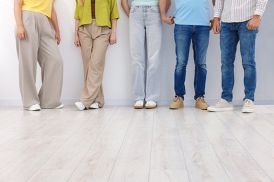 Photo of Group of people waiting in queue indoors, closeup