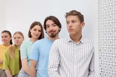 Photo of Group of people waiting in queue indoors