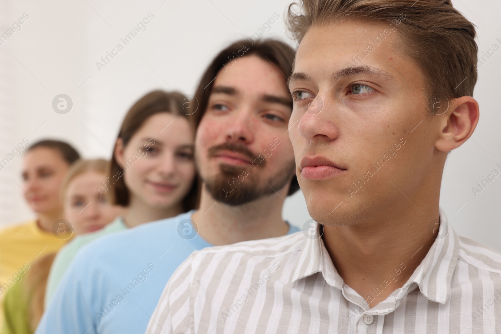 Group of people waiting in queue indoors, selective focus Photo of Group of people waiting in queue indoors, selective focus