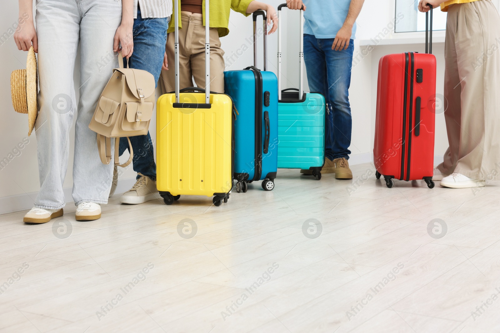 People with luggages waiting in queue indoors, closeup Photo of People with luggages waiting in queue indoors, closeup