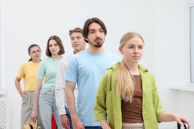 Photo of People waiting in queue indoors, selective focus
