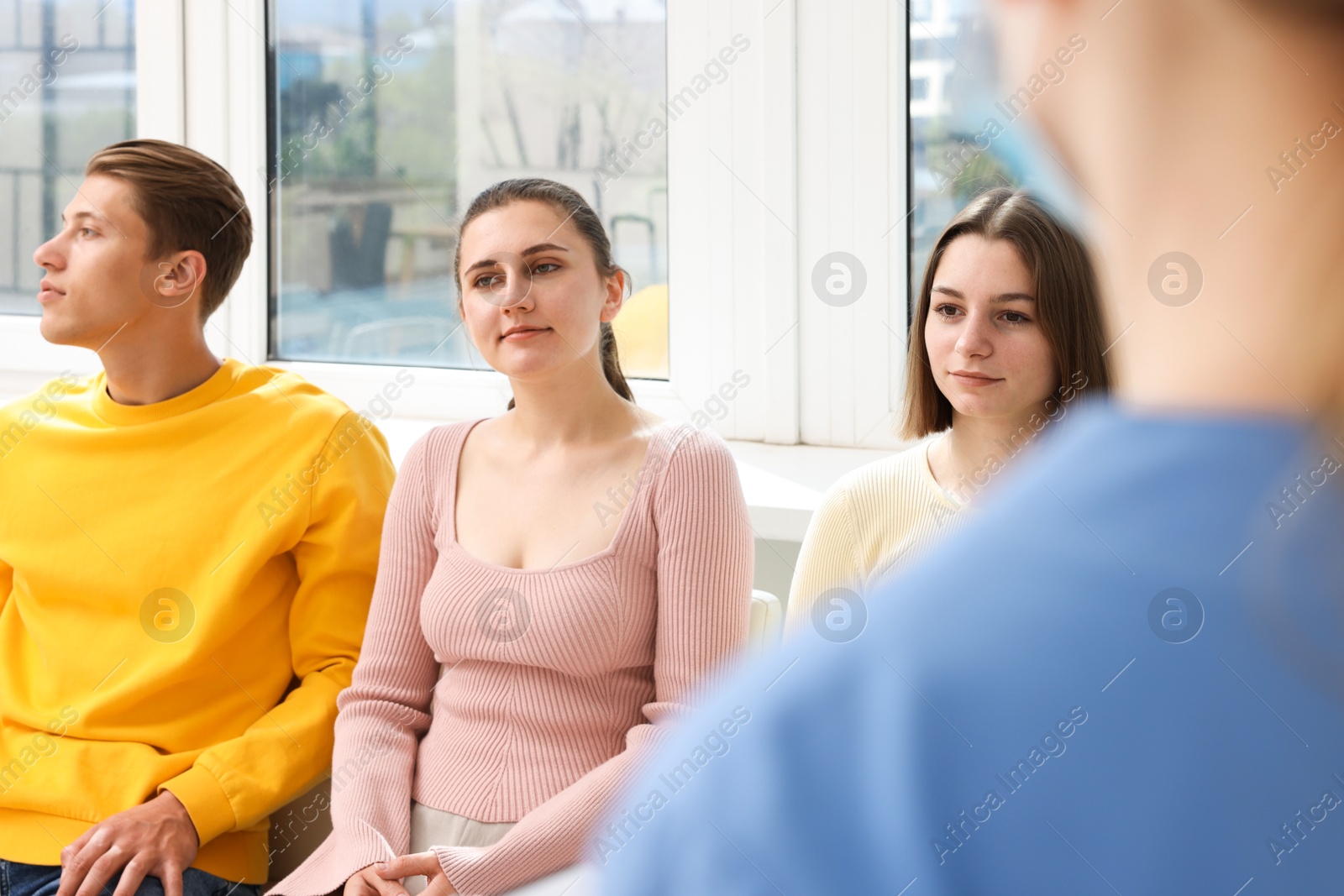 People waiting in queue on chairs at hospital, selective focus Photo of People waiting in queue on chairs at hospital, selective focus