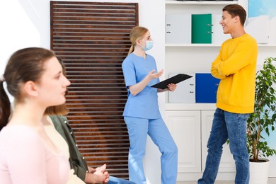 Photo of People waiting in queue at hospital, selective focus