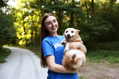Photo of Volunteer with cute stray dog outdoors. Animal rescue