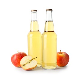 Photo of Delicious cider in glass bottles and apples isolated on white