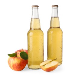 Photo of Delicious cider in glass bottles and apples isolated on white