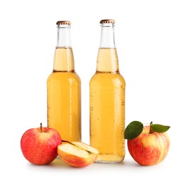 Photo of Delicious cider in glass bottles and apples isolated on white