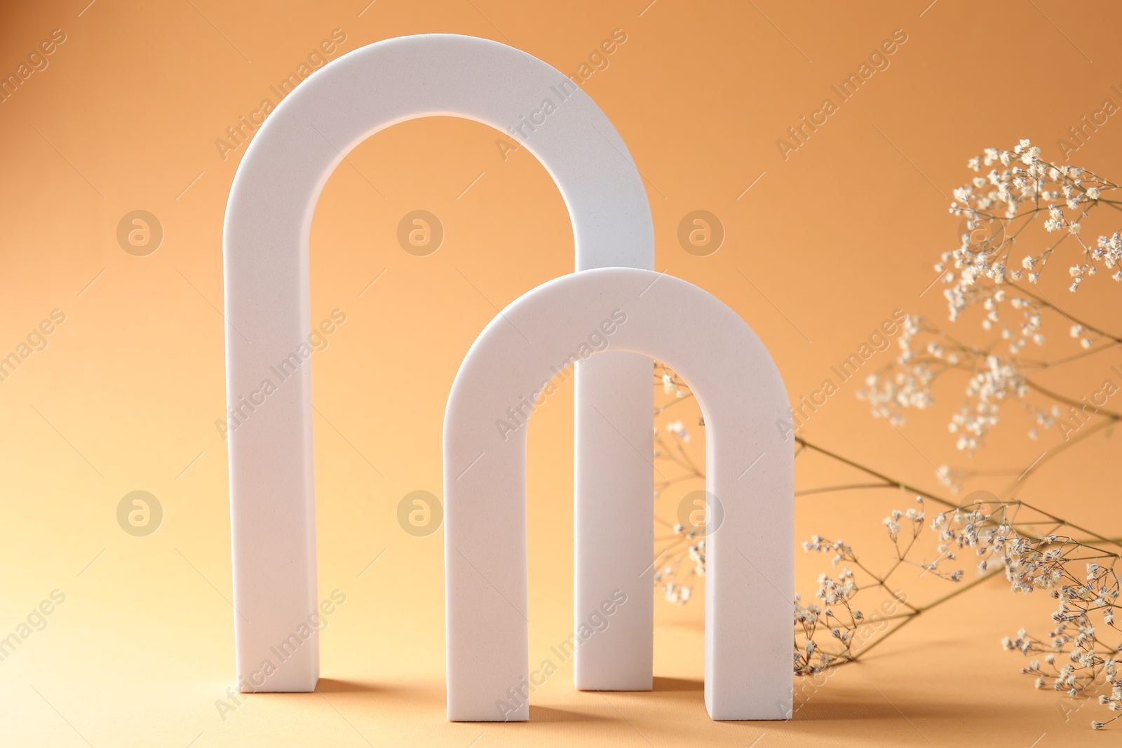 Photo of Promotion. White figure and gypsophila flowers on beige background