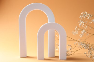 Photo of Promotion. White figure and gypsophila flowers on beige background