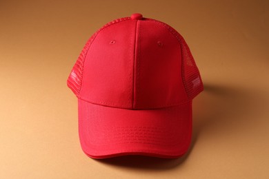 Photo of Promotion. One red cap on brown background