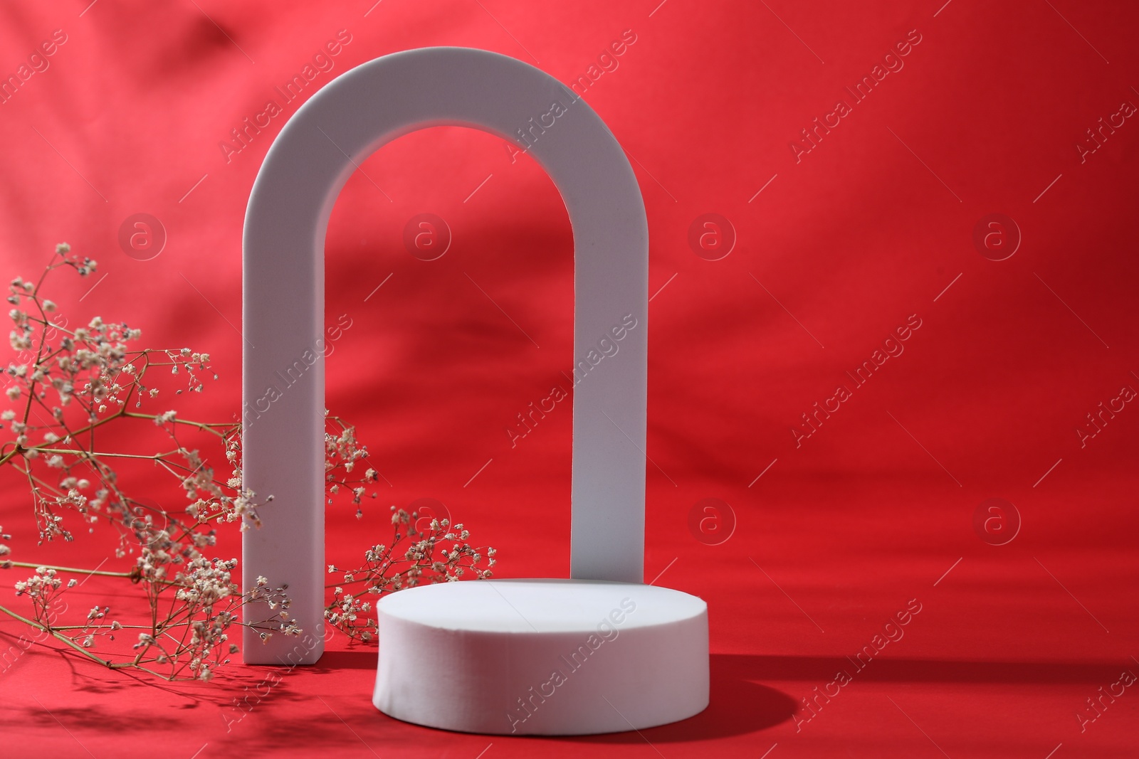 Photo of Promotion. White figures and gypsophila flowers on red background
