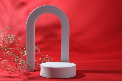 Photo of Promotion. White figures and gypsophila flowers on red background