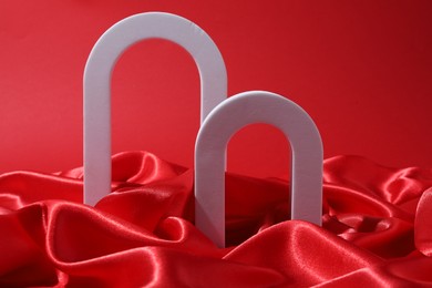 Photo of Promotion. White figures and fabric on red background