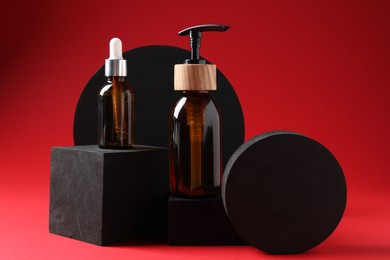 Photo of Promotion. Cosmetic products and podiums on red background