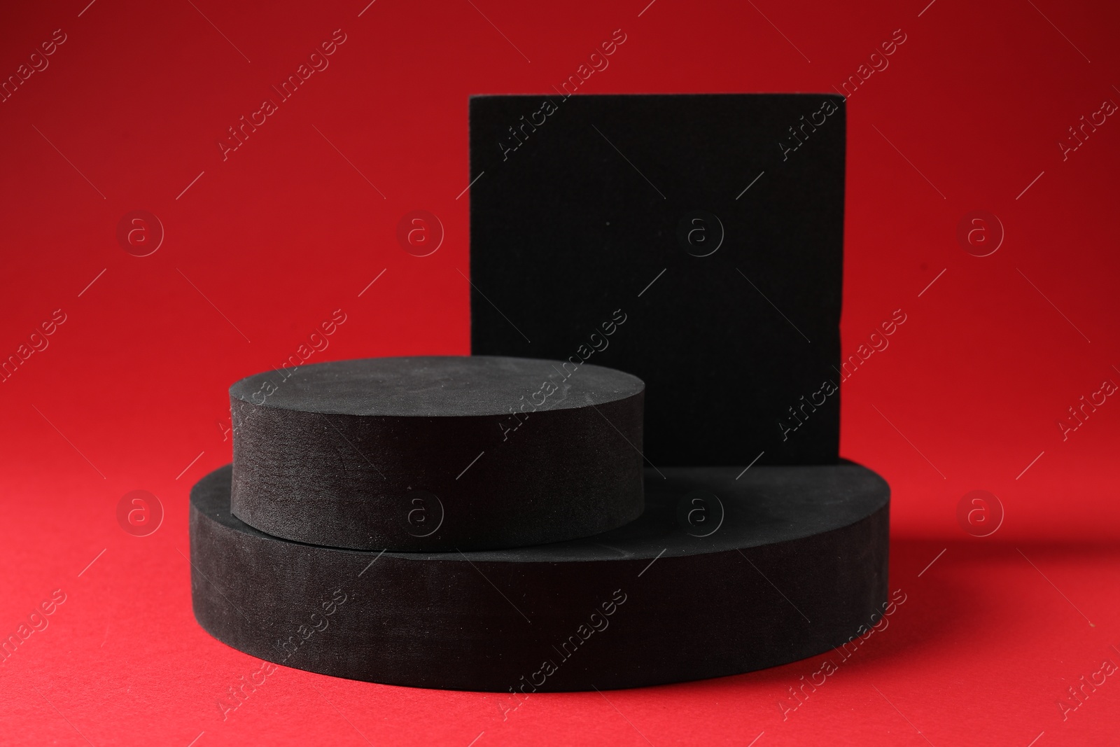 Photo of Promotion. Different podiums for product presentation on red background
