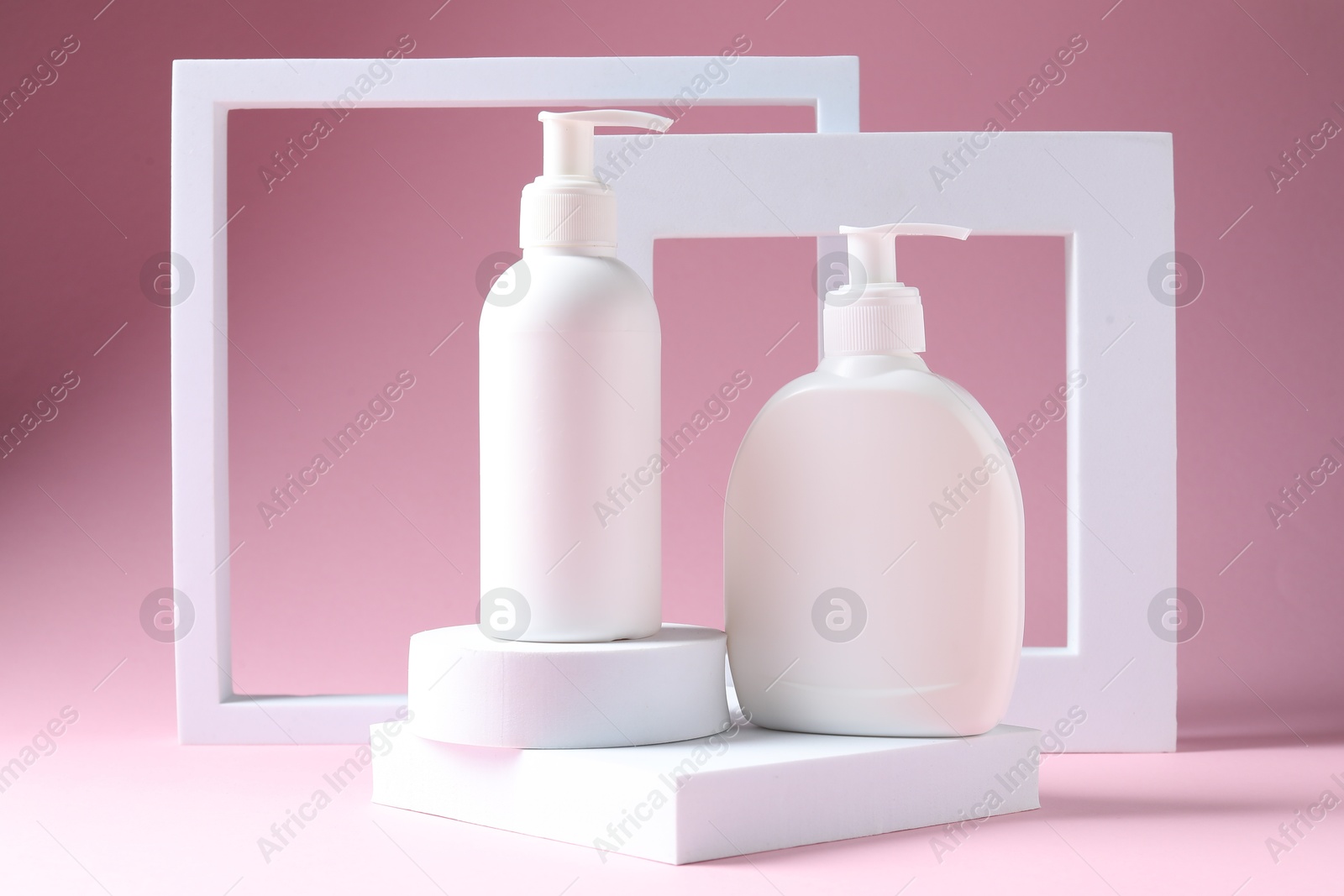 Photo of Promotion. Cosmetic products and podiums on pink background