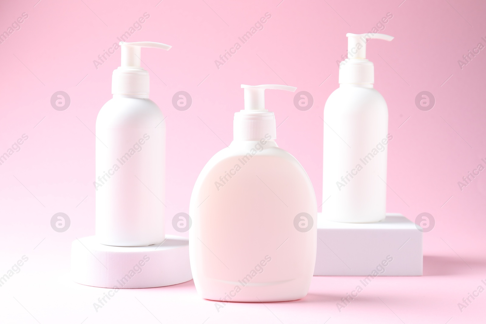 Photo of Promotion. Cosmetic products and podiums on pink background