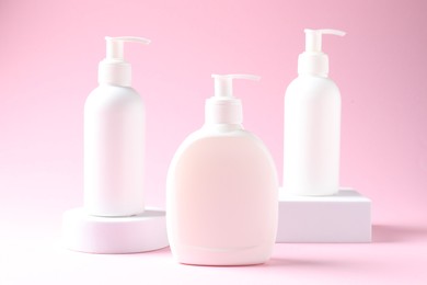 Photo of Promotion. Cosmetic products and podiums on pink background