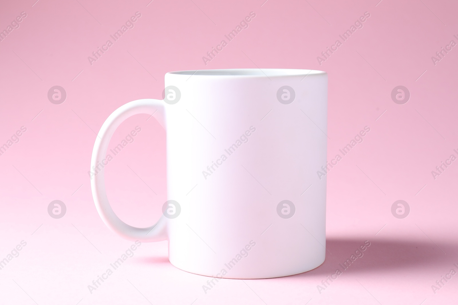 Photo of Promotion. White mug on pink background. Mockup for design