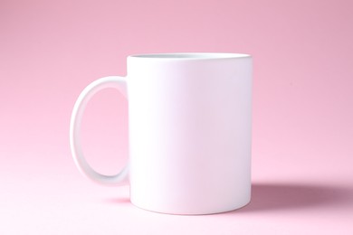 Photo of Promotion. White mug on pink background. Mockup for design
