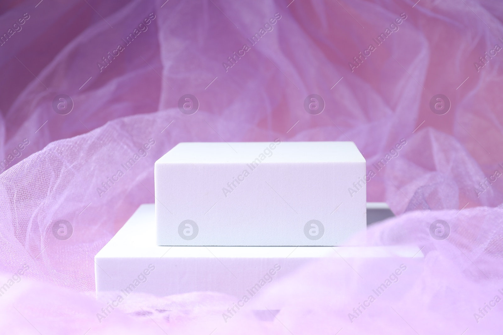Photo of Promotion. Podiums for product presentation on violet fabric