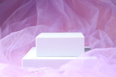Photo of Promotion. Podiums for product presentation on violet fabric