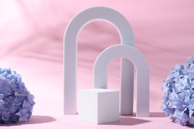 Photo of Promotion. White figures and hydrangea flowers on pink background
