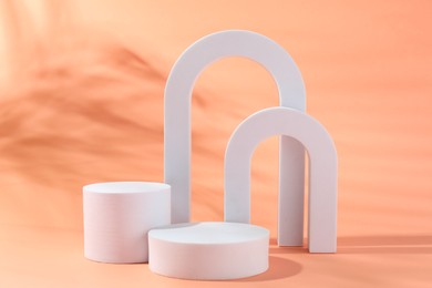 Photo of Promotion. Different podiums for product presentation on coral background